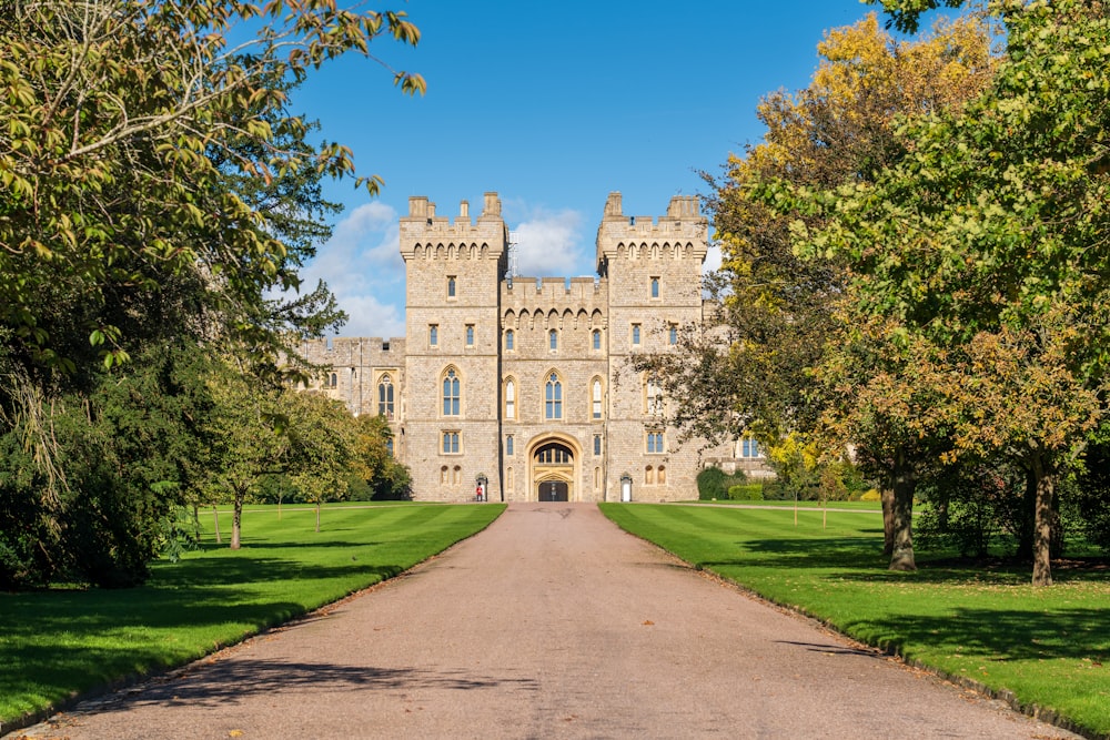 a large castle with a long driveway leading to it