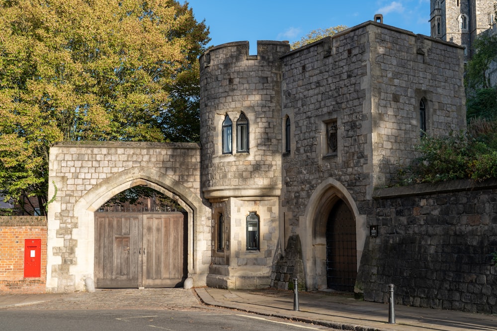 a stone building with a red door on the side of it