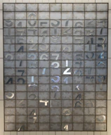 Close-up of traditional numerology grids with golden accents, highlighting name and date vibrations.