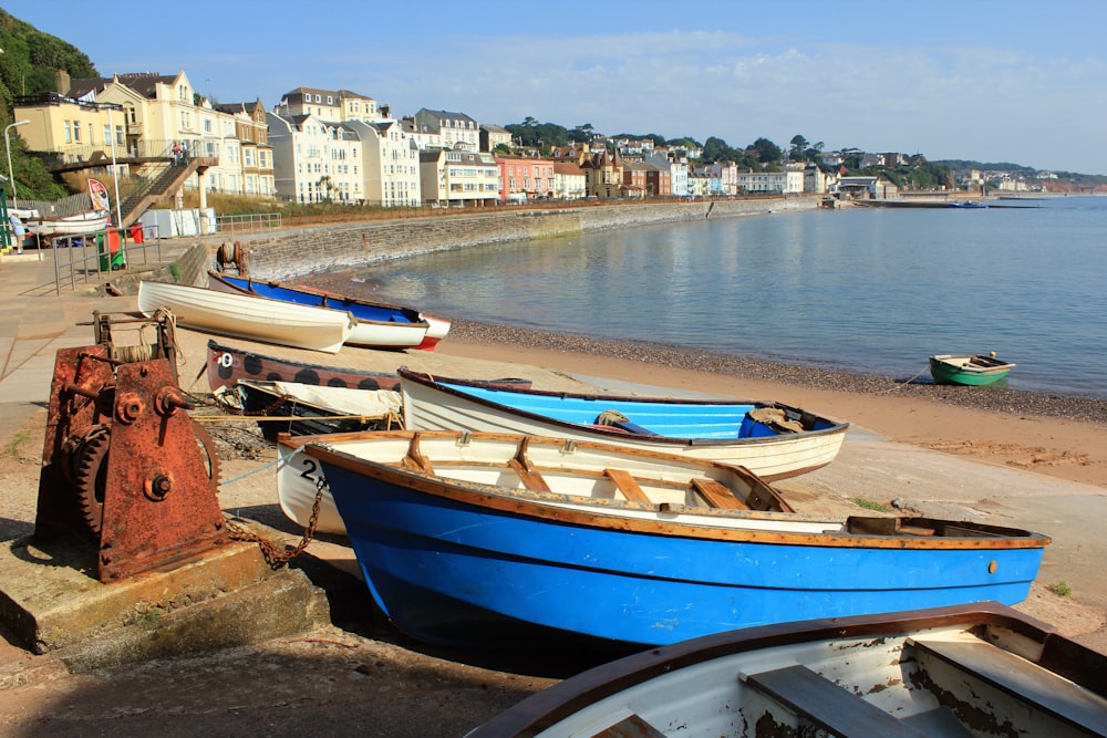 a group of boats sitting on top of a beach