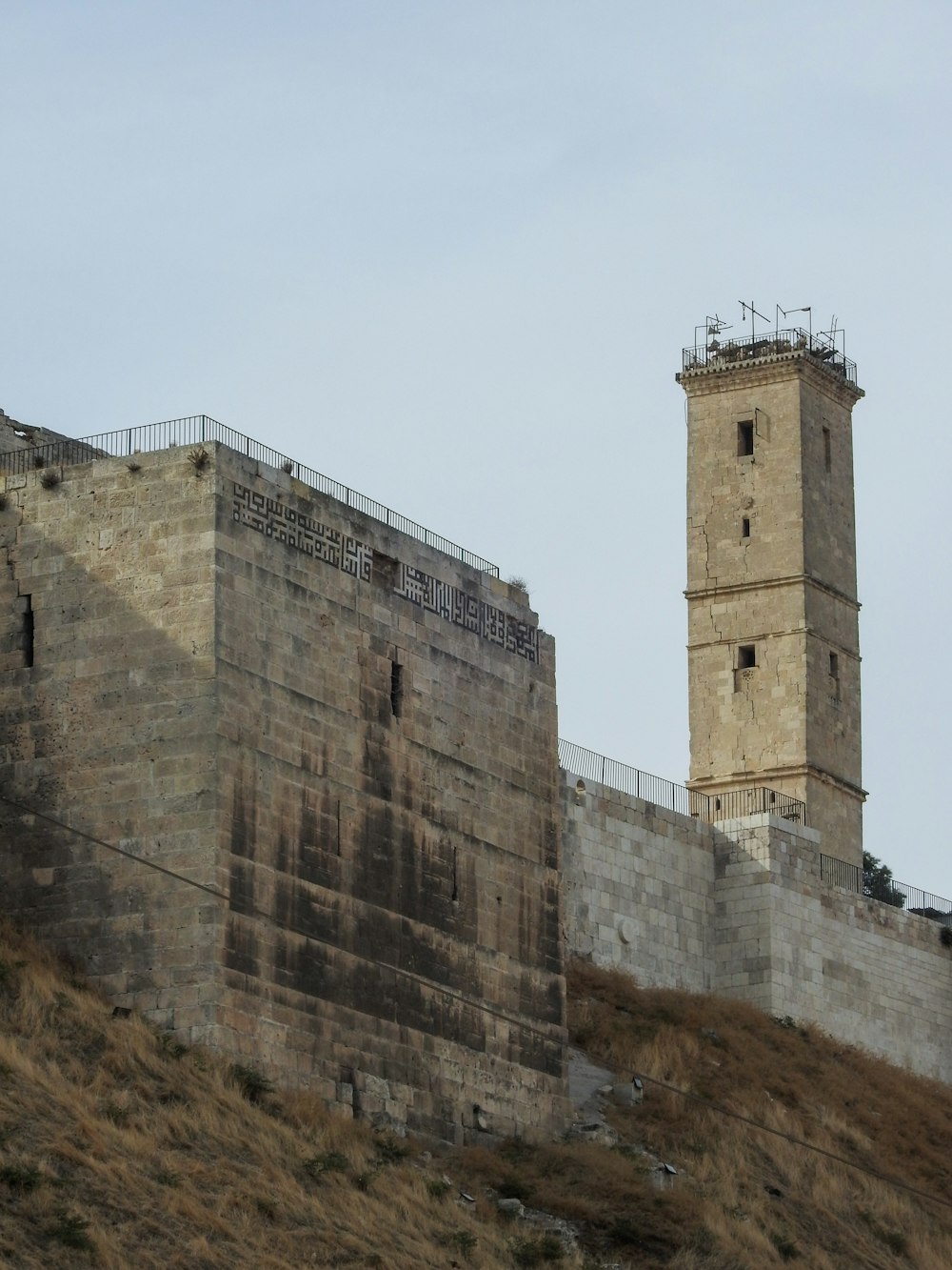 a stone wall with two towers on top of it