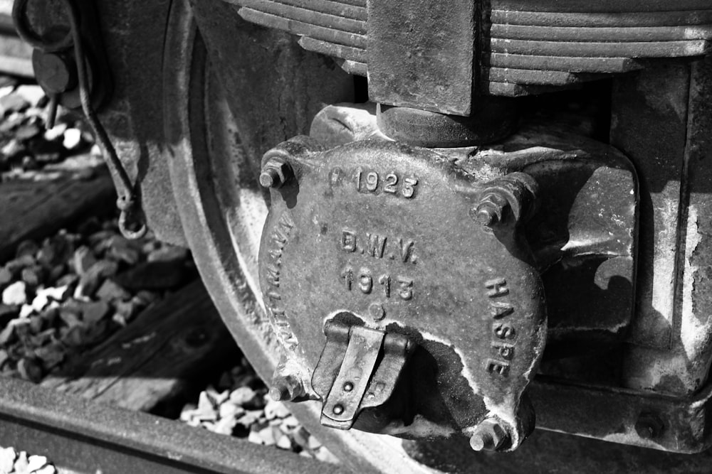 a black and white photo of a train wheel