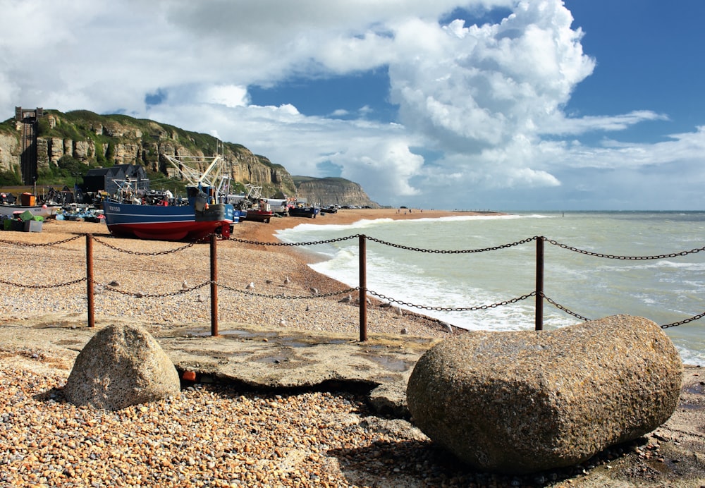 a large rock sitting on top of a sandy beach