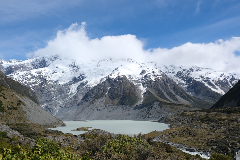 a mountain range with a lake in the foreground