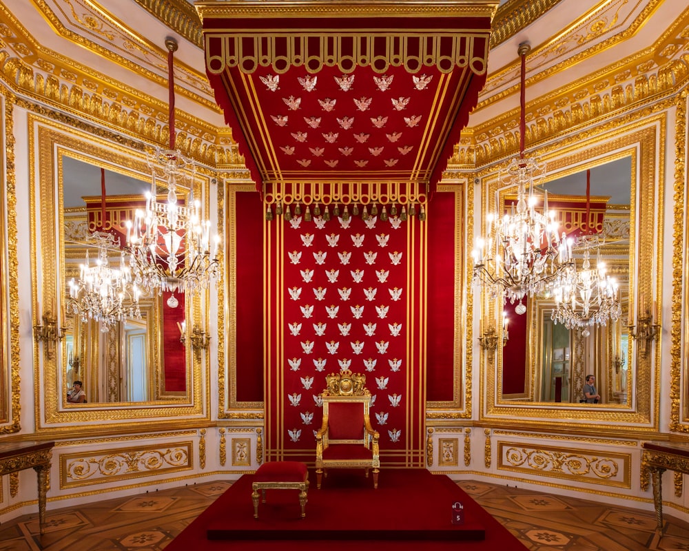 a room with a red carpet and a gold chair