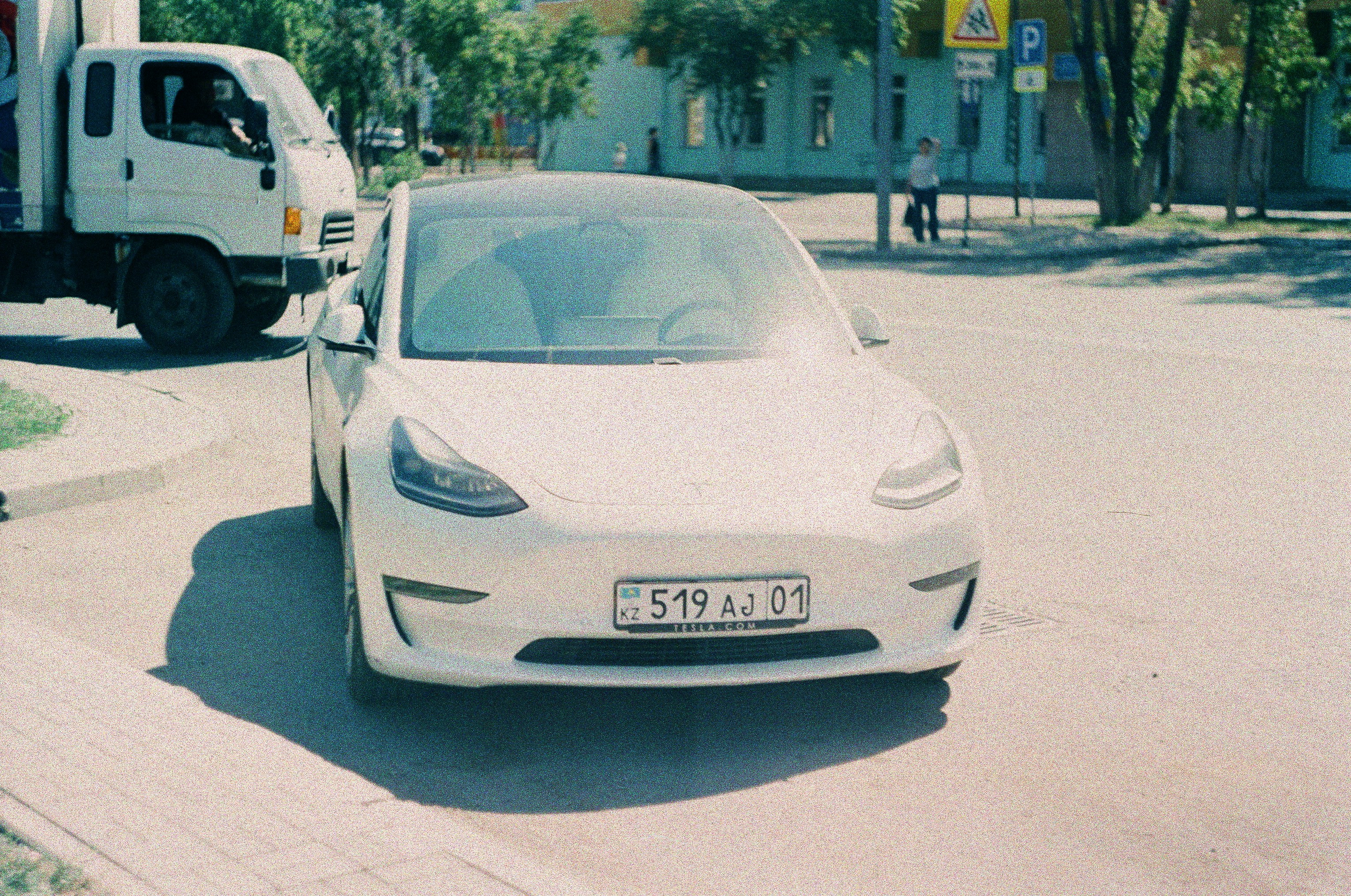 Customer smiling while finalizing paperwork for a used electric vehicle