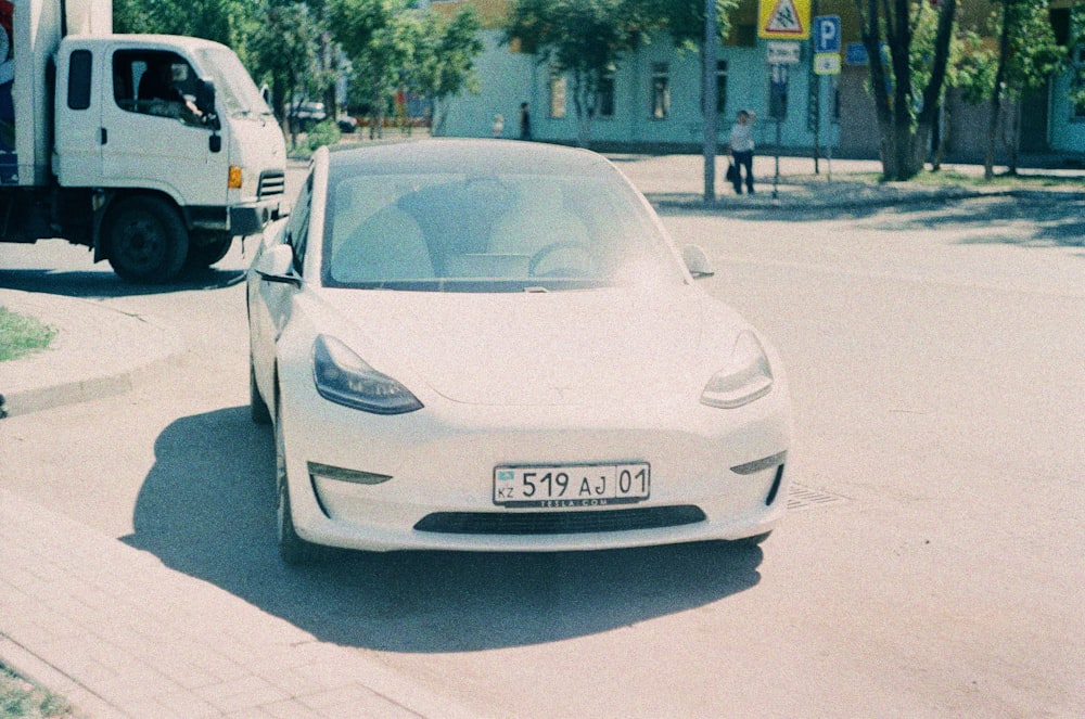 a white car parked on the side of the road