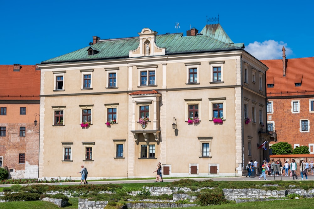 a group of people standing outside of a large building