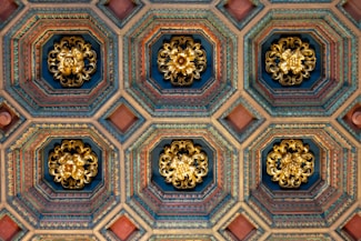 the ceiling of a building with ornate designs on it