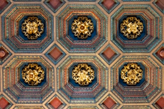 the ceiling of a building with ornate designs on it