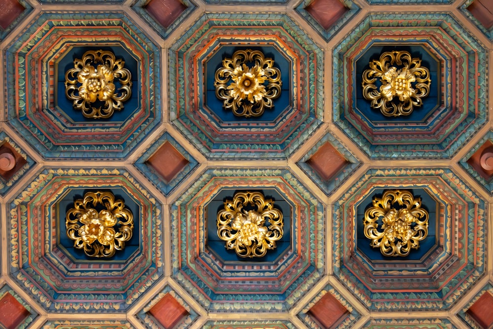 the ceiling of a building with ornate designs on it