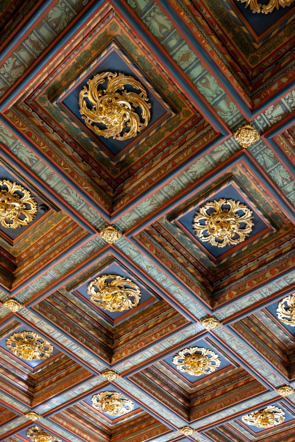 the ceiling of a building with ornate designs on it