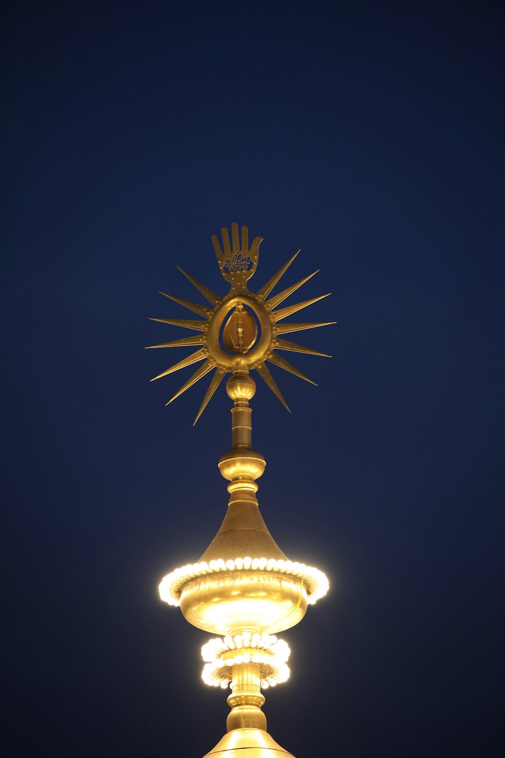 a golden clock tower with a star on top