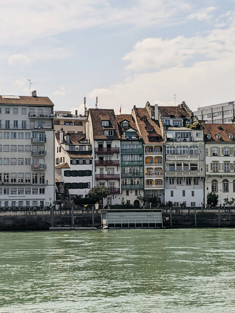 a row of buildings next to a body of water