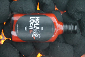 Bold packaging and identity design for The Love Hot Sauce featuring warm reds and simple graphics.