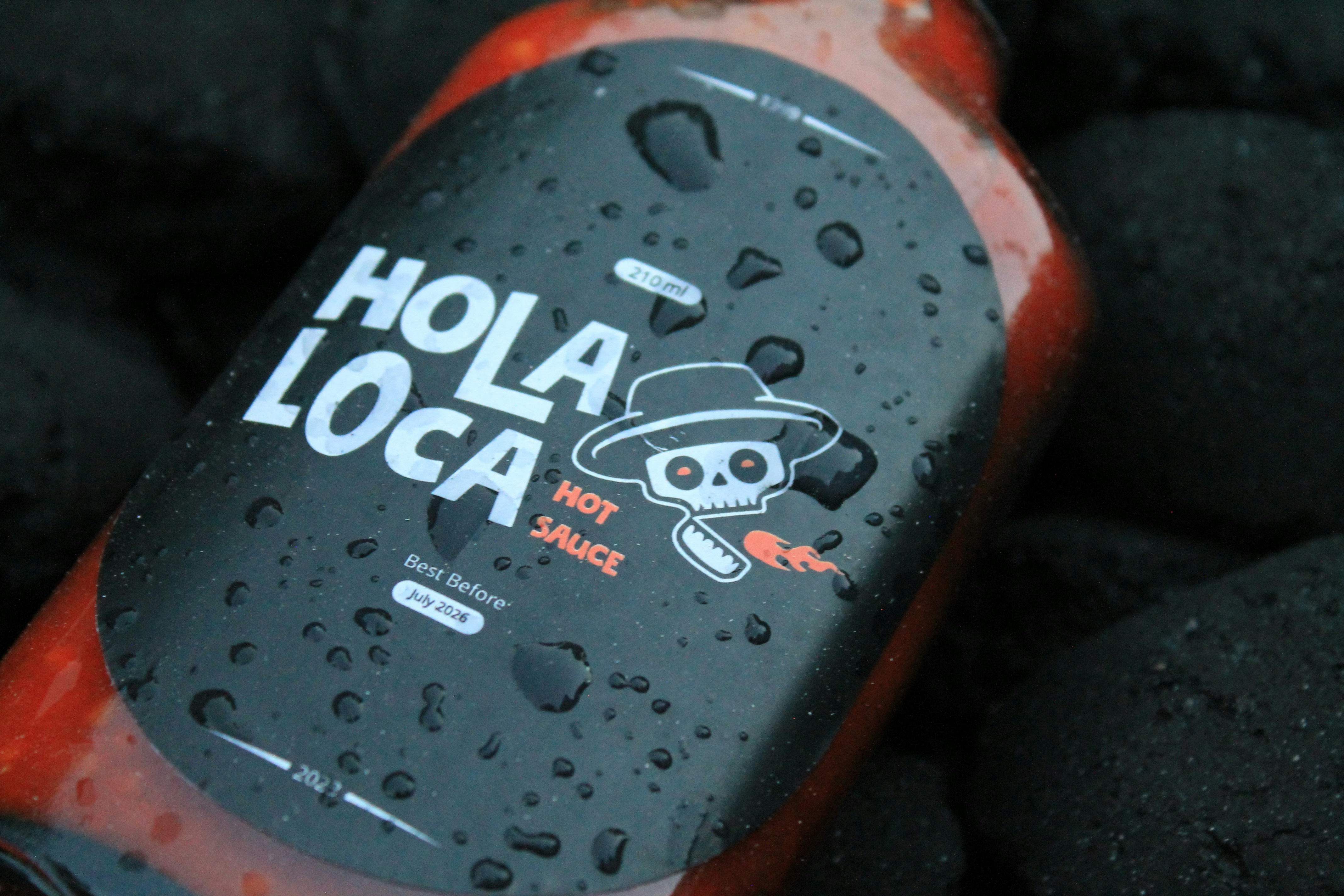 a bottle of hot sauce with a skull on it