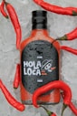 a bottle of hot sauce sitting on top of ice