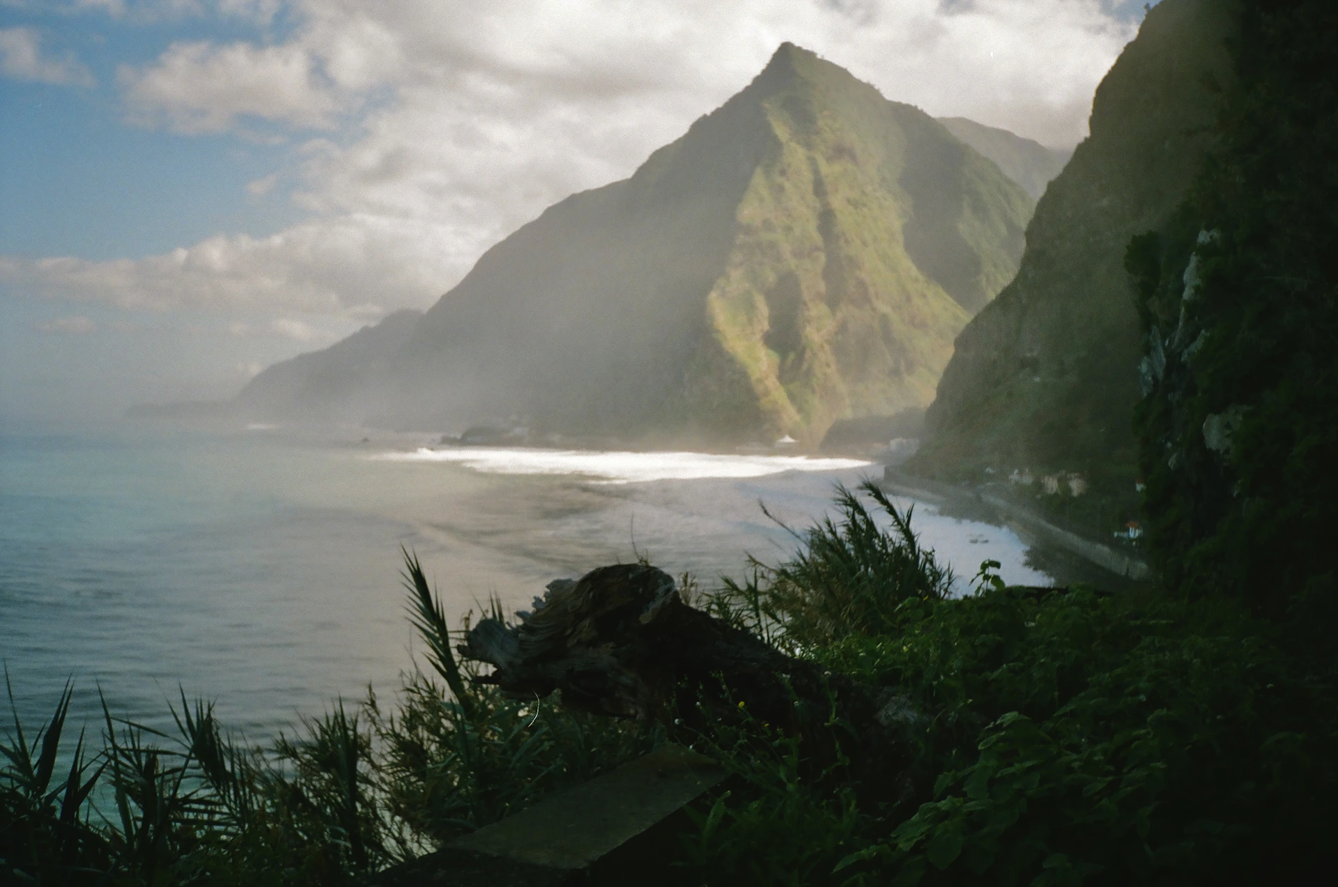 a view of a beach with a mountain in the background