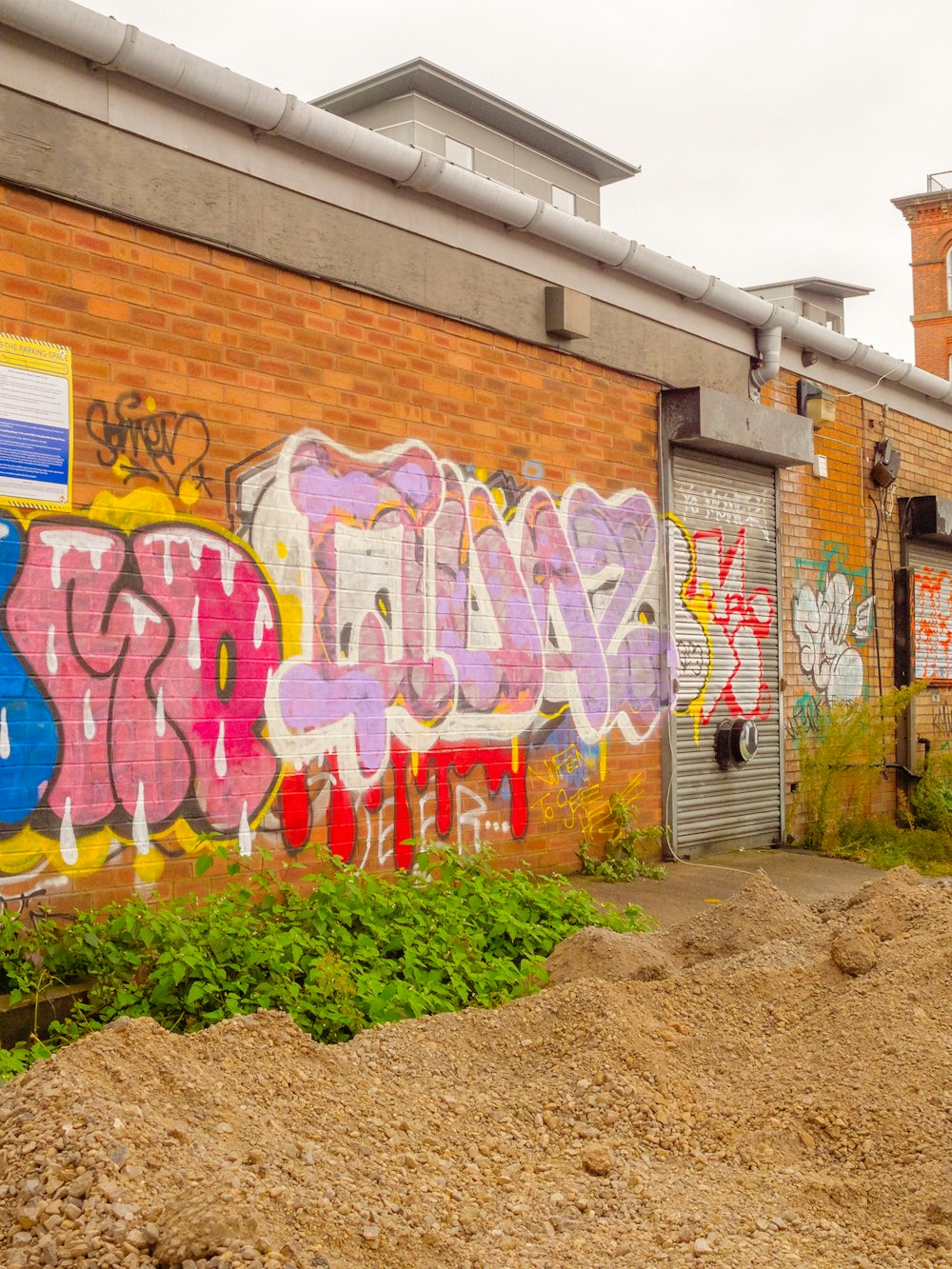 a brick building with graffiti all over it