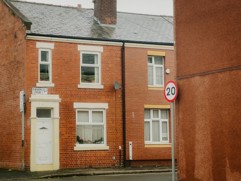 a red brick building with a white door and number 20 on it