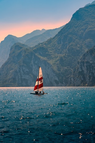 Close-up of a classic wooden sailboat cutting through Bear Lake’s clear blue water.