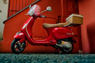 Electric scooter being delivered to the doorstep of a stylish riad in Marrakech.