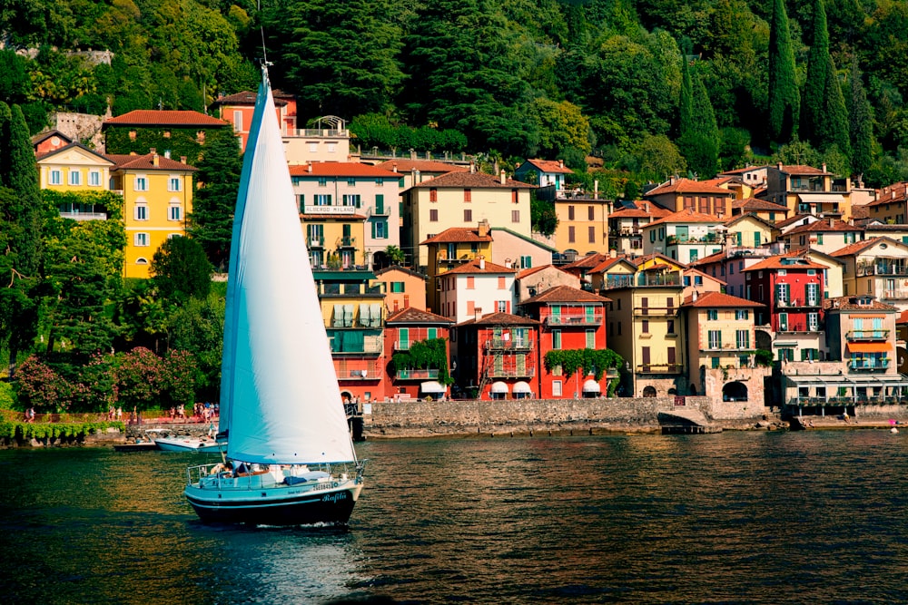 a sailboat in a body of water near a city