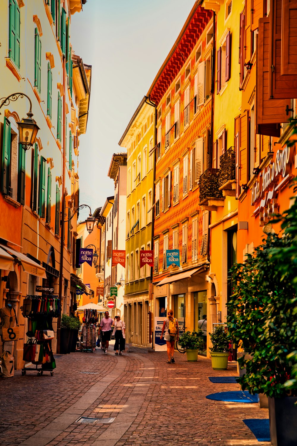 a cobblestone street lined with tall buildings