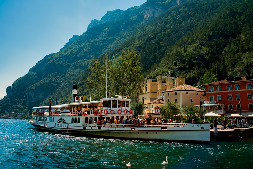 a large boat with people on it in the water