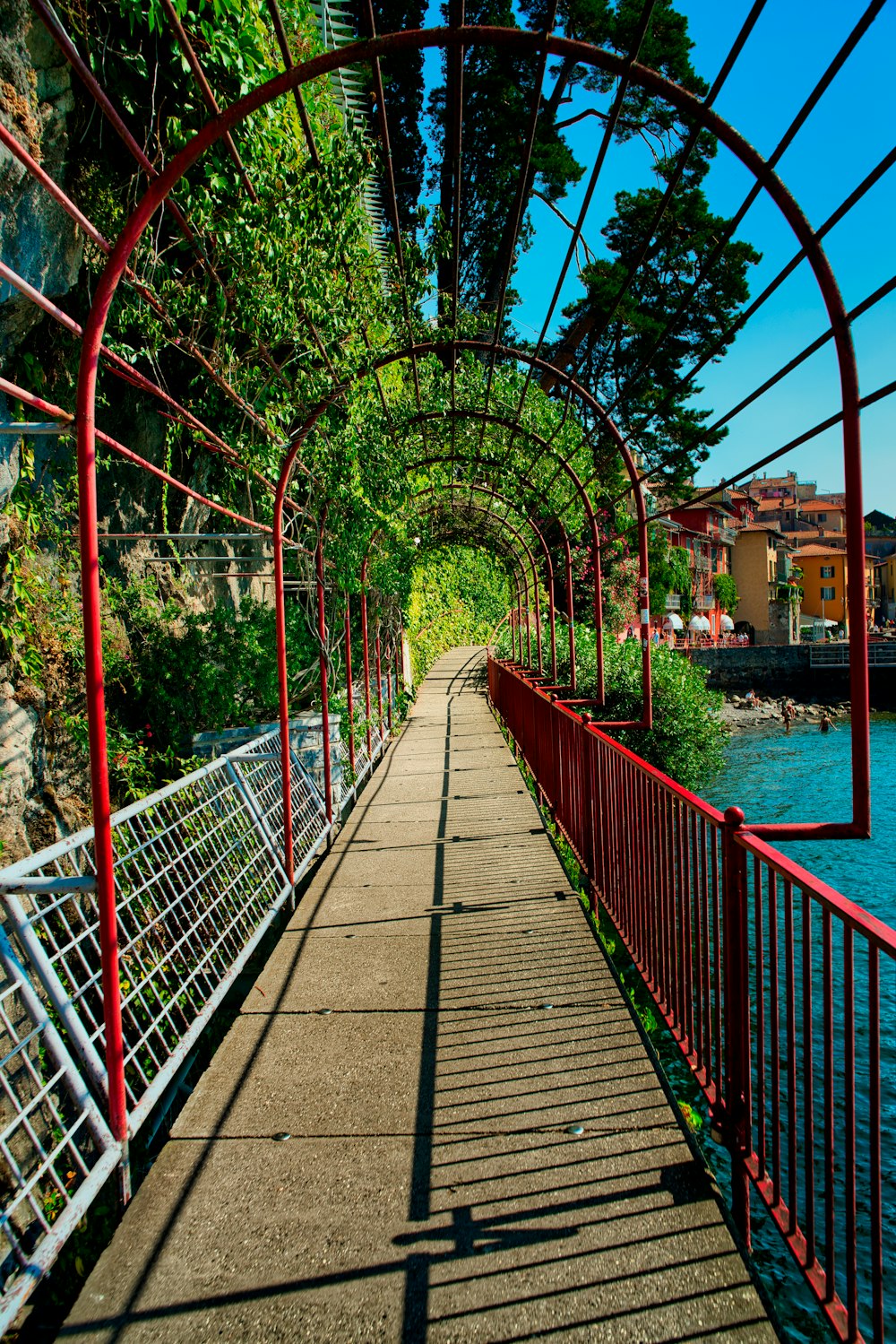 a long walkway with a red metal railing