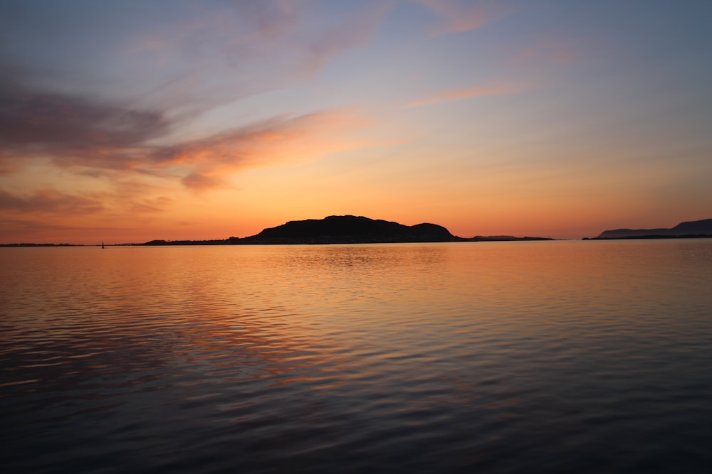 a large body of water with a small island in the distance