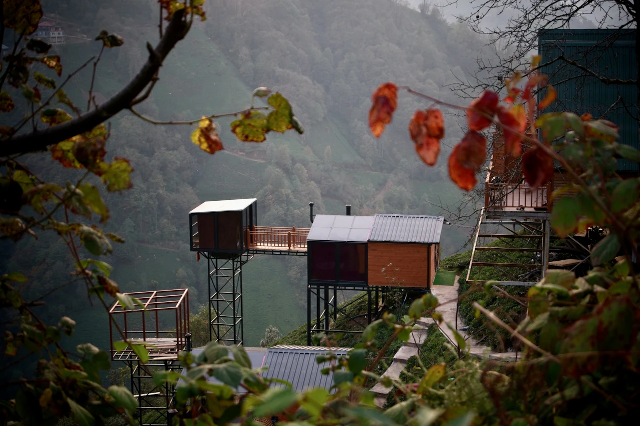 Wooden bungalows above a misty valley in Rize