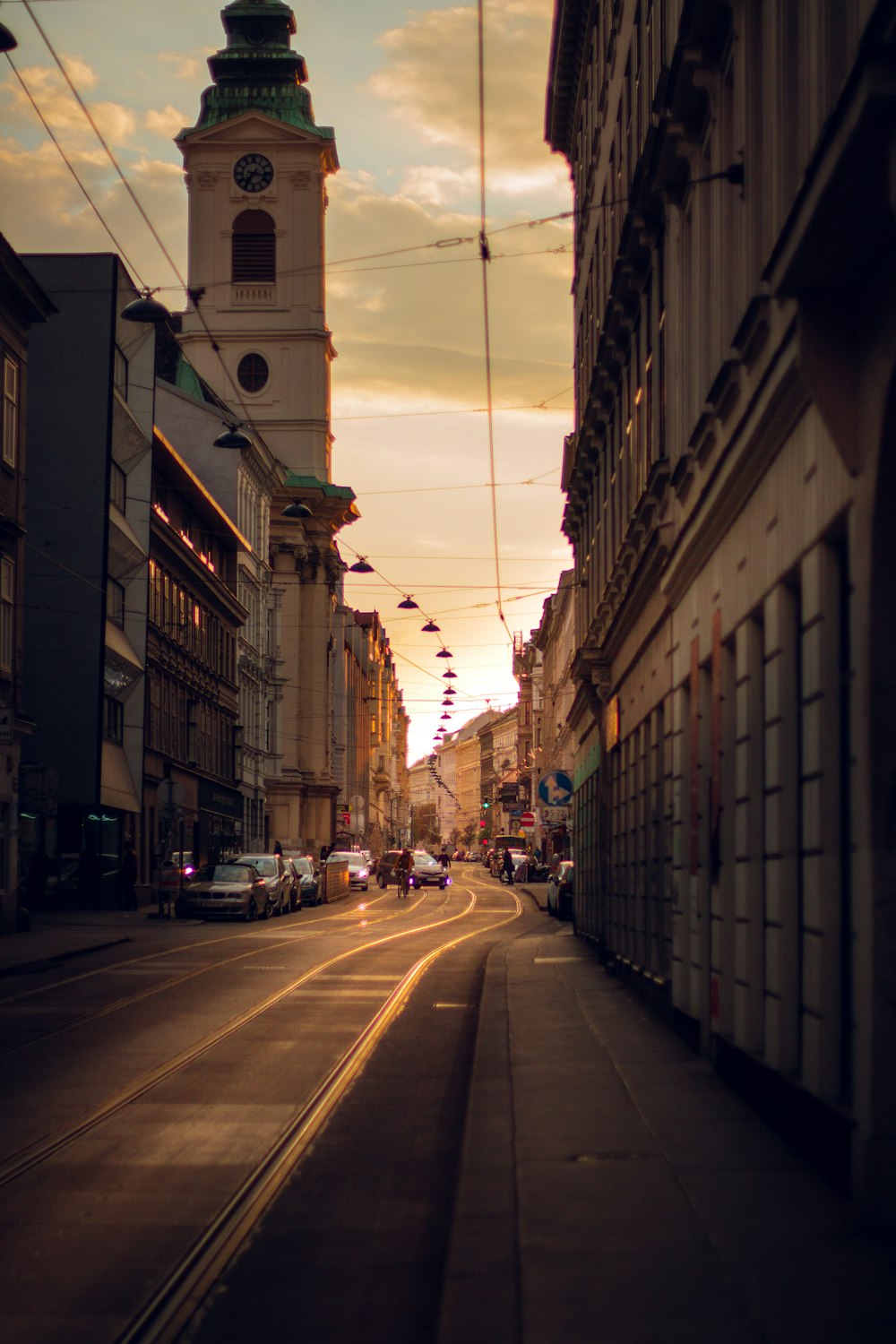 a city street with a clock tower in the background