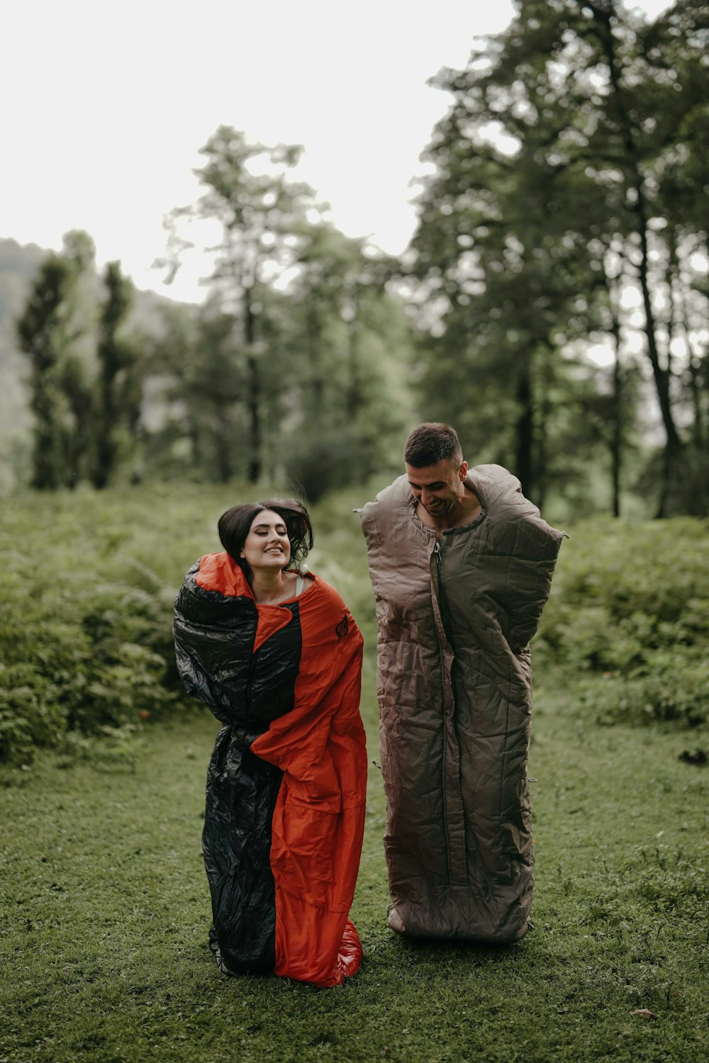 a man and a woman standing next to each other in a field