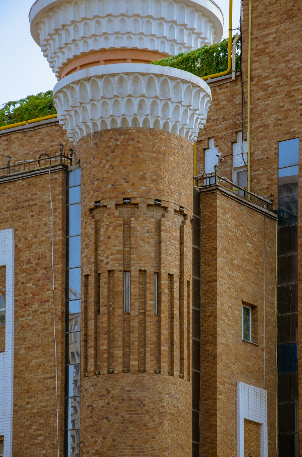 a tall brick building with a clock on the top of it