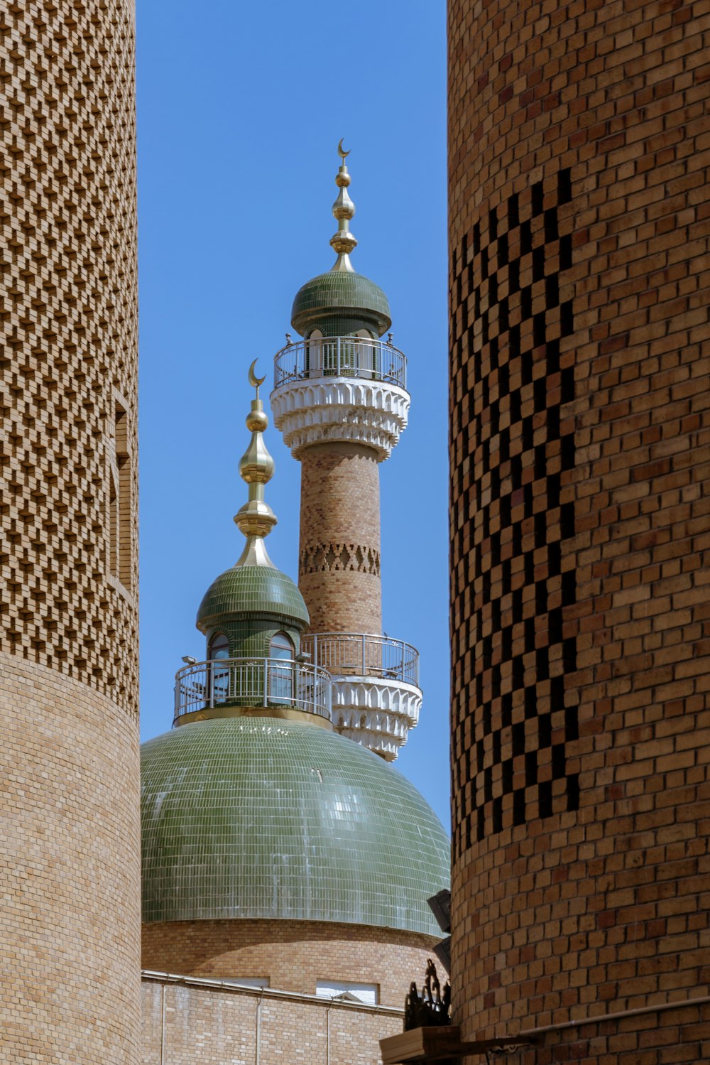 a tall building with a green dome on top of it