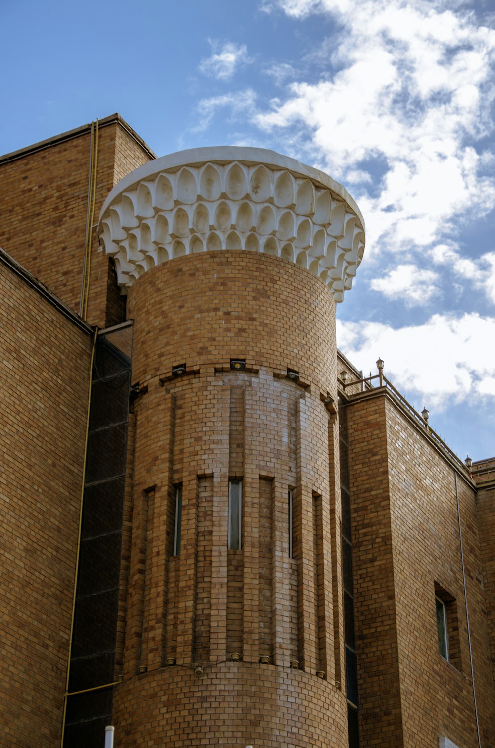 a large brick building with a clock on it's side