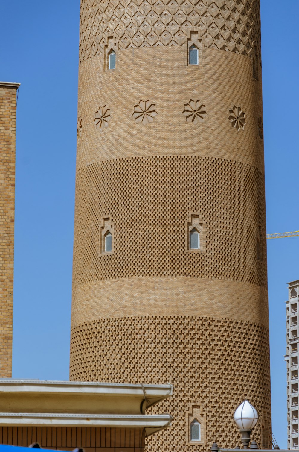 une haute tour en brique avec une horloge sur le côté