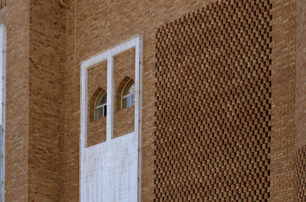 a brick building with a white door and window