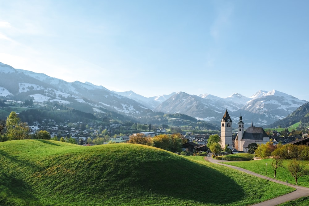 a church in the middle of a lush green field