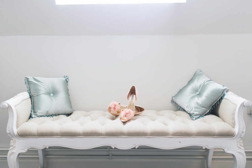 a white bench with a pair of shoes on top of it