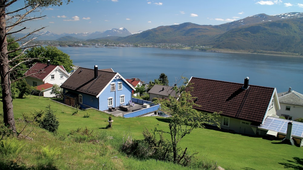 a blue house with a view of a body of water