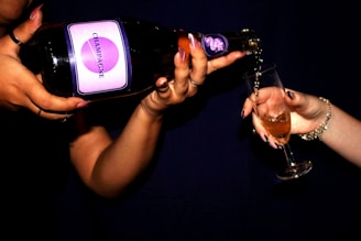 A close-up of a sparkling champagne bottle being poured into a flute.