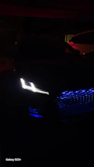 A stylish car illuminated by vibrant LED lights highlighting its contours at night.