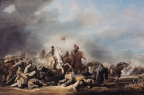 A historical battle scene with numerous soldiers engaged in combat. Some soldiers are on horseback, with one prominently placed white horse in the center. Soldiers on foot are wielding spears and swords. The sky is cloudy with smoke, suggesting the chaos and intensity of the battle. There are injured or fallen soldiers on the ground, highlighting the brutality of the conflict.