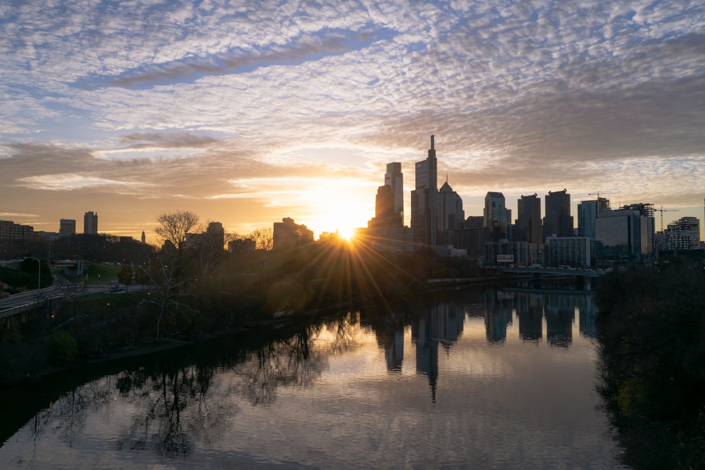 the sun is setting over the city skyline