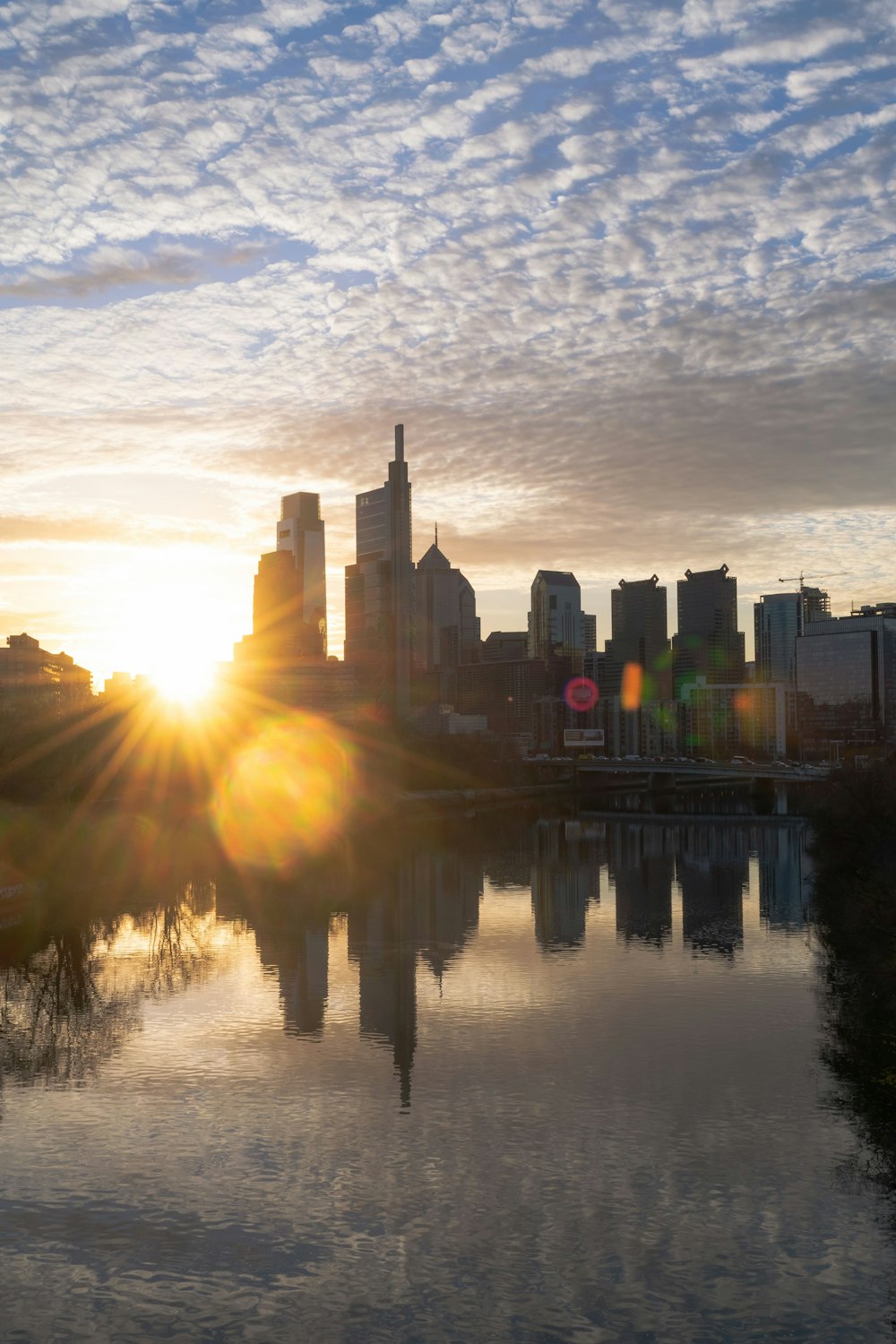 the sun is setting over the city skyline