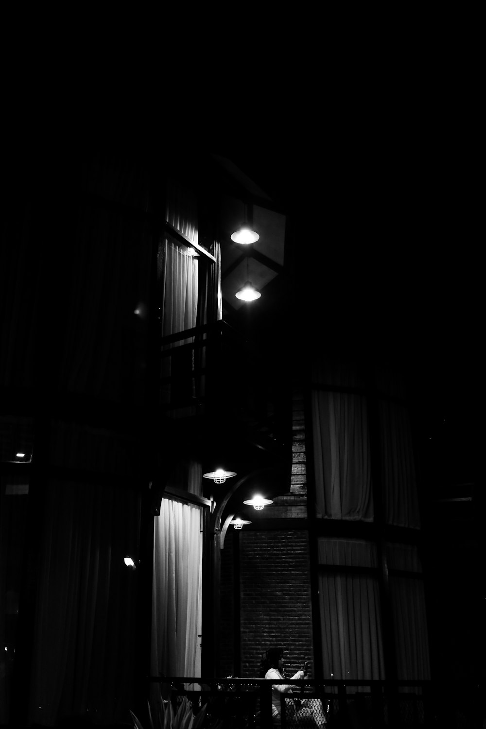 a black and white photo of a building at night