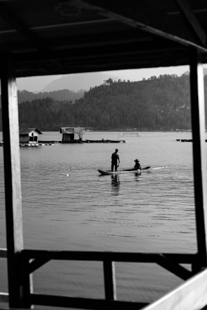 a couple of people on a boat in the water