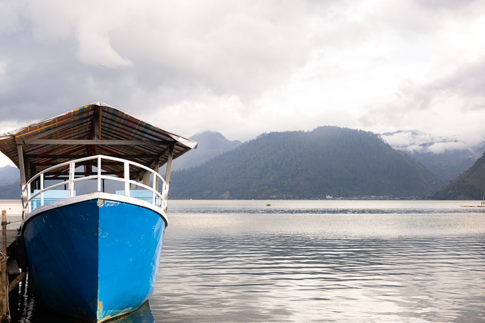 a blue boat sitting on top of a body of water